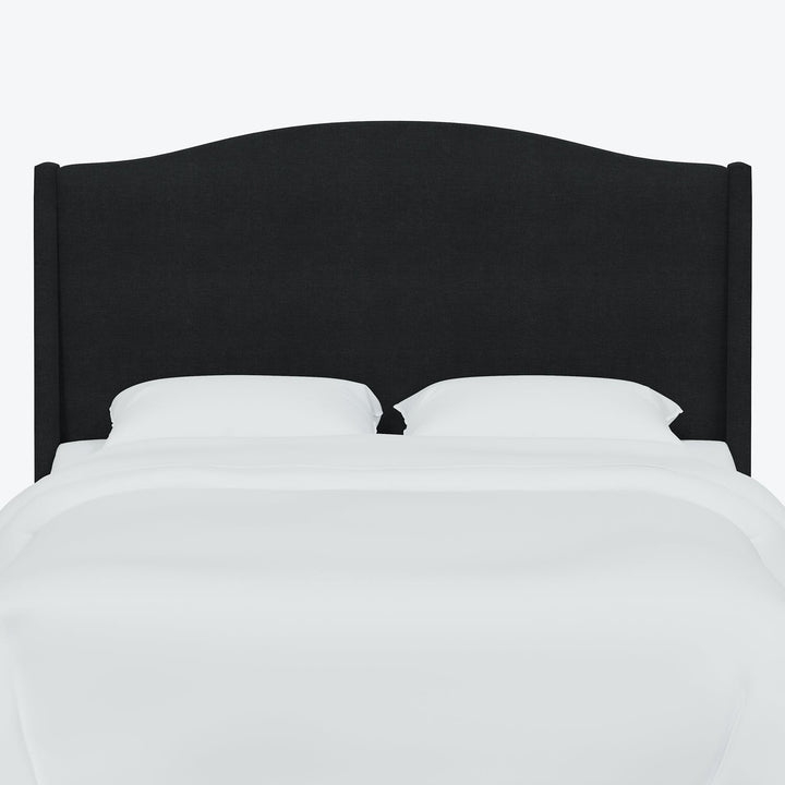 Sleek modern bed with black headboard exudes minimalist elegance.