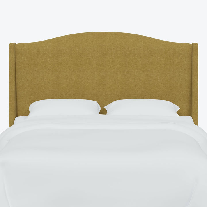 Minimalist bed with tan upholstered headboard exudes modern simplicity.