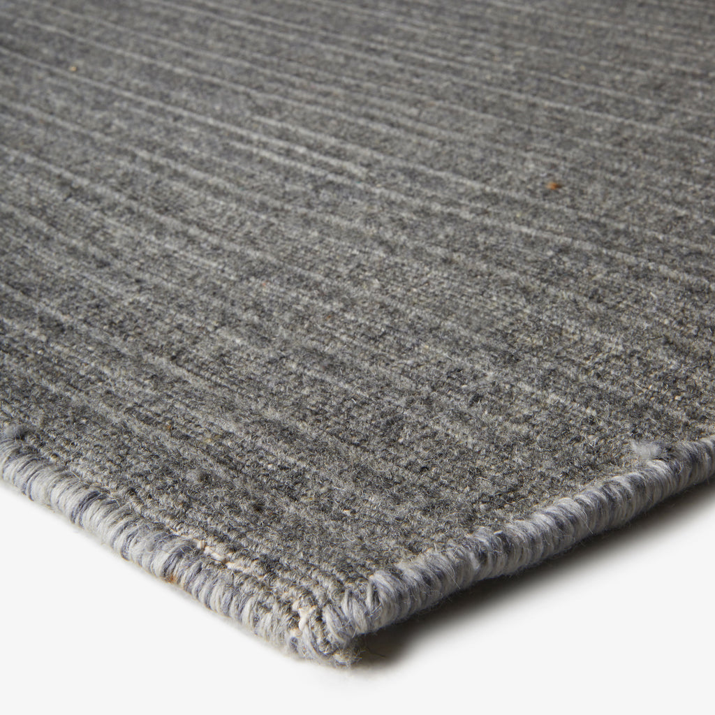 Close-up of high-quality gray fabric with ribbed texture for decor.