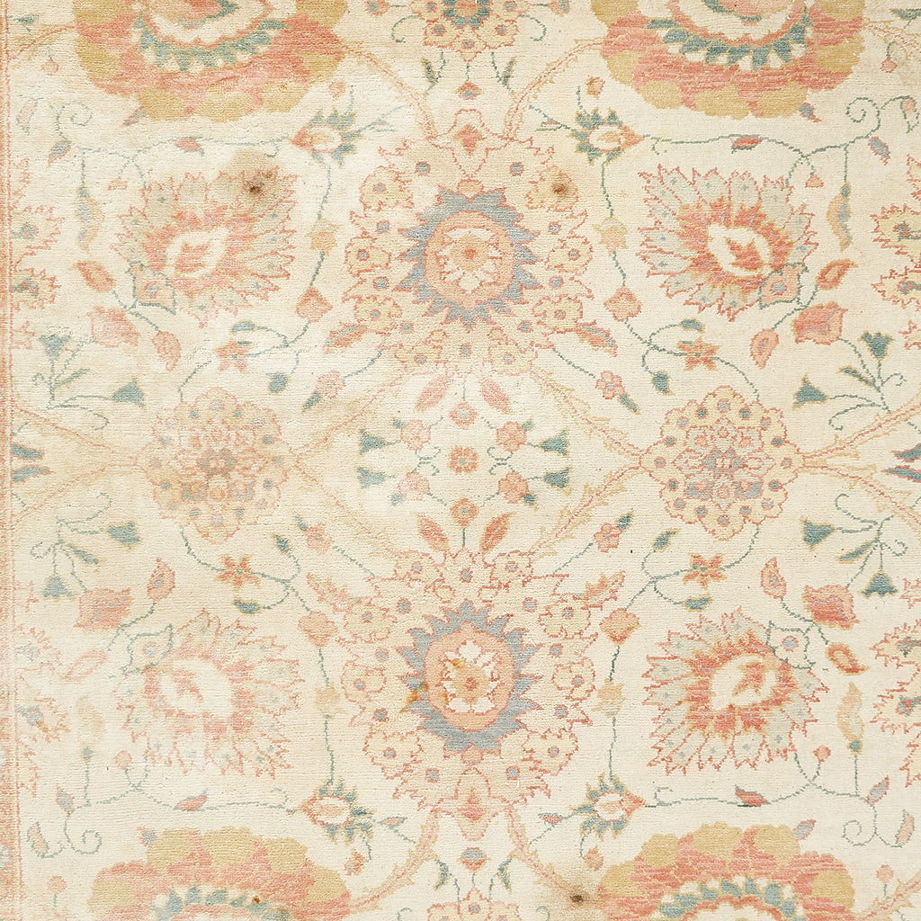 Intricate floral pattern in soft pastel colors on fabric close-up