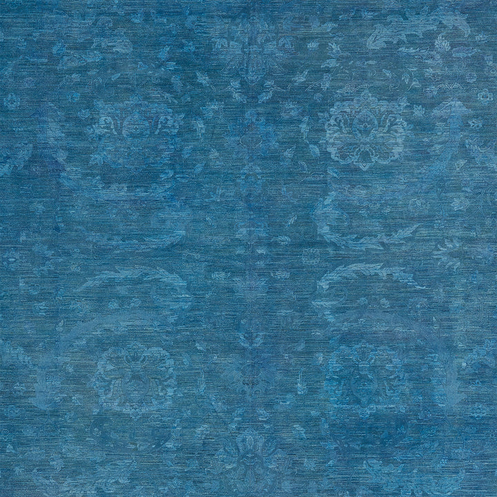Vintage blue floral fabric design with symmetrical and weathered pattern.