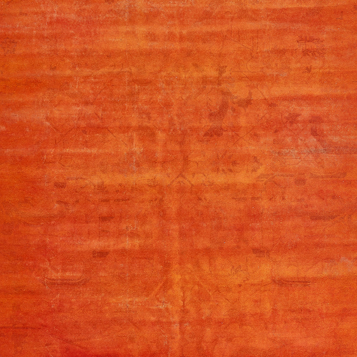 Rough, textured surface in warm red tones with brush marks.