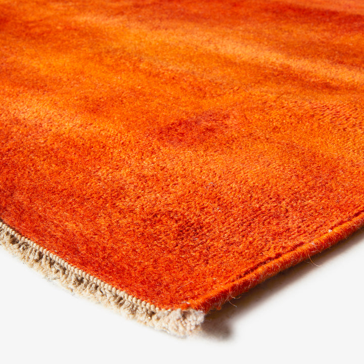 Gradient orange area rug with soft dense texture and binding.