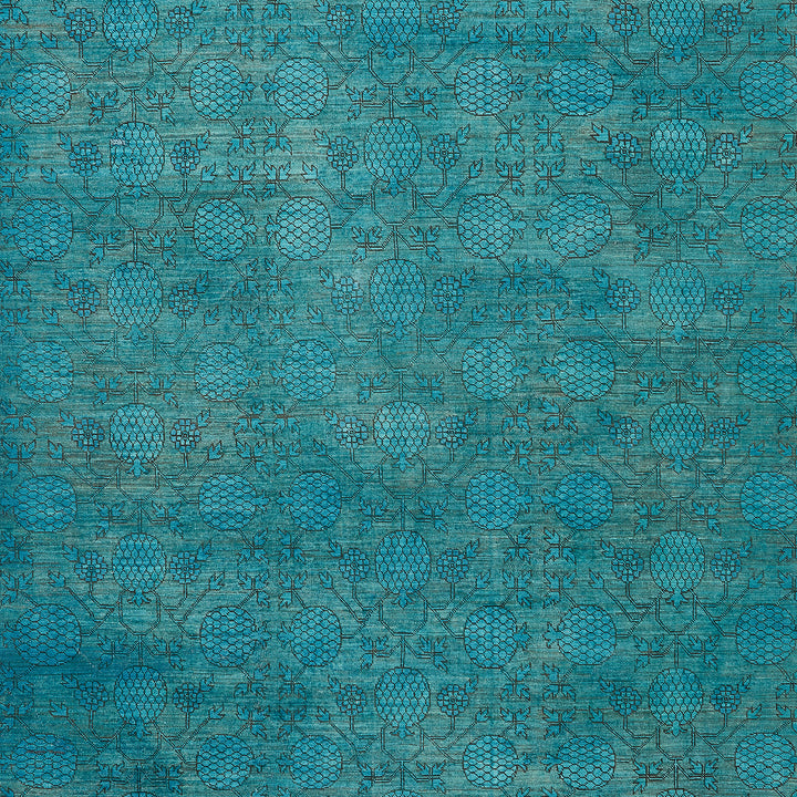 Intricate teal blue textile design with stylized floral motifs.