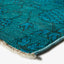 Vibrant turquoise rug with dark blue geometric patterns, high pile.