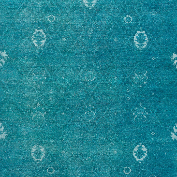 Vintage teal fabric with diamond pattern and floral motifs distressed.