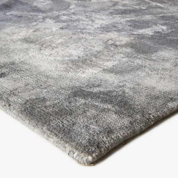 Plush gray gradient rug with vintage distressed look, quality craftsmanship.