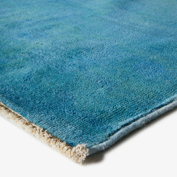 Close-up of high-quality blue gradient rug with plush texture.