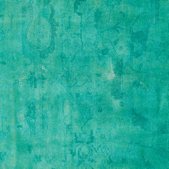 Textured surface in greenish-blue with mottled pattern and antiqued look.