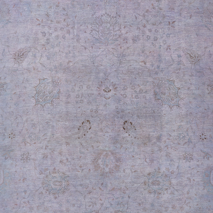 Intricate faded textile pattern with floral motifs in muted tones.