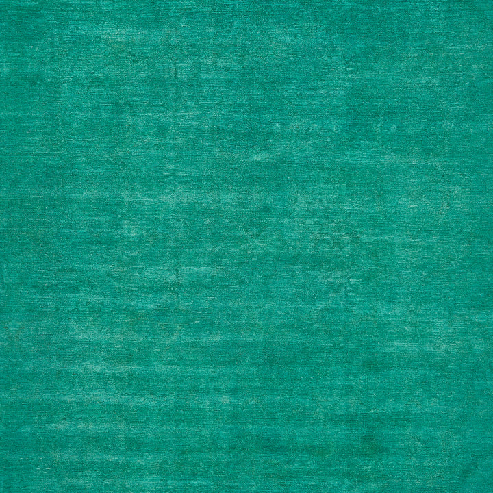 Close-up of textured teal surface with mottled fabric appearance.