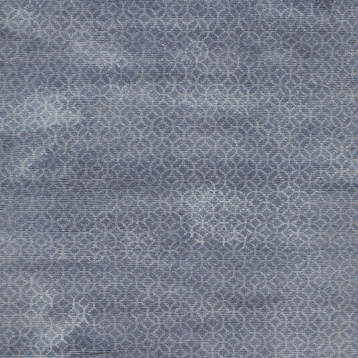 Intricate blue textured fabric with geometric Moroccan tile design pattern.