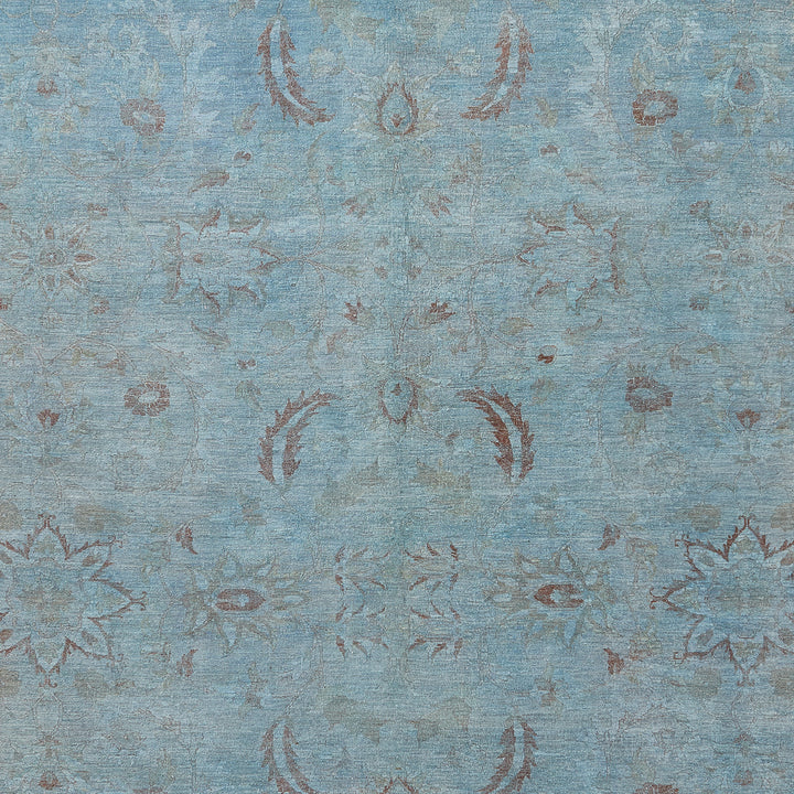 Vintage distressed blue fabric with symmetrical floral and paisley motifs.