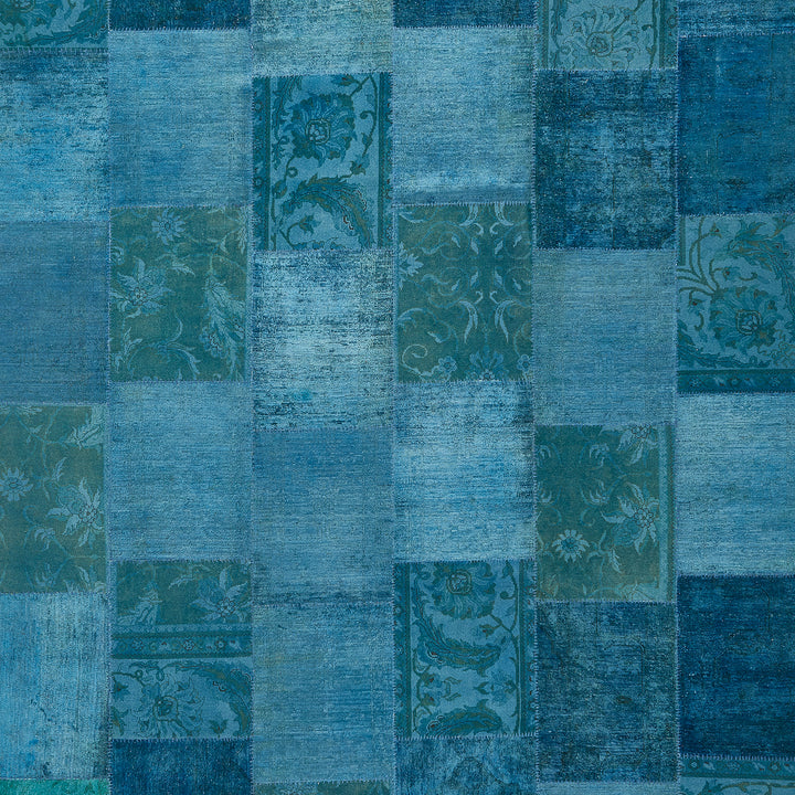 Blue patchwork textile with various patterns and distressed vintage look.