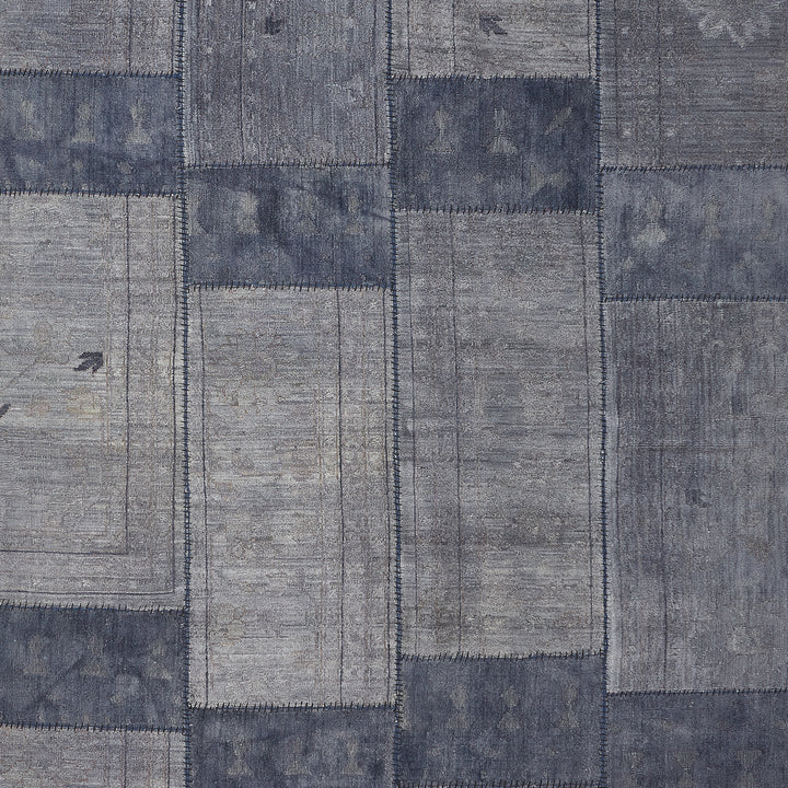 Denim-inspired patchwork fabric with worn texture in shades of blue