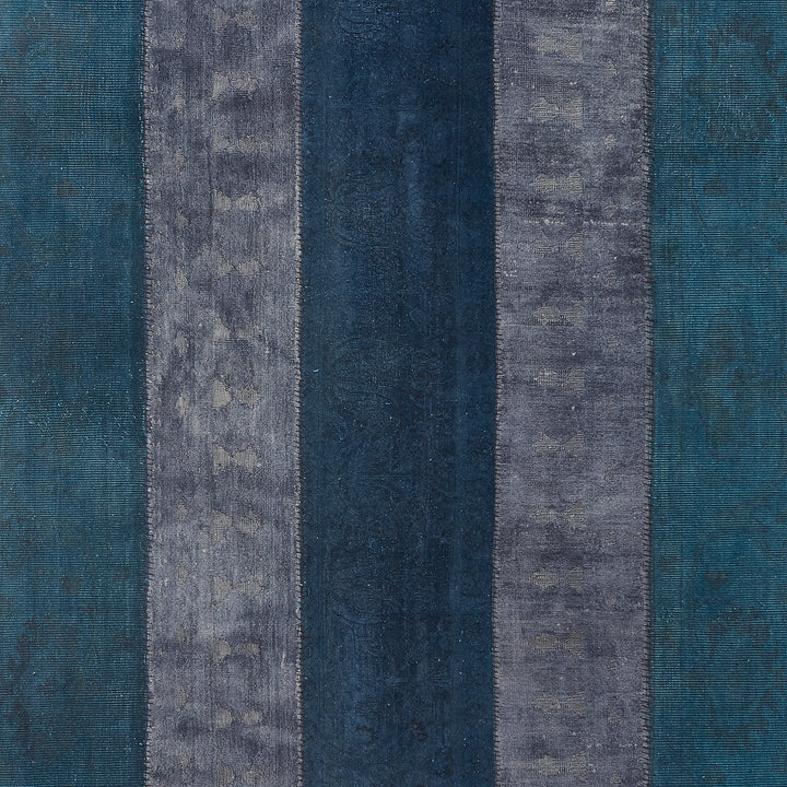 Textile sample with varying shades of blue and gray stripes.