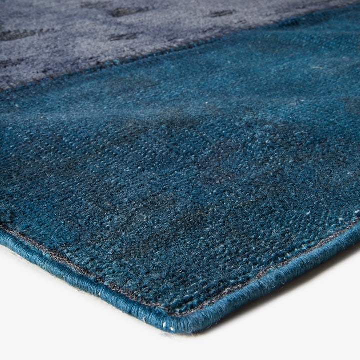 Gradient design rug with plush texture, dark gray to vibrant blue.