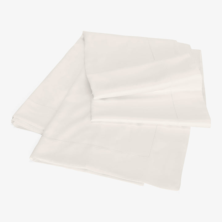 Neatly folded white sheet on white background with clean design.