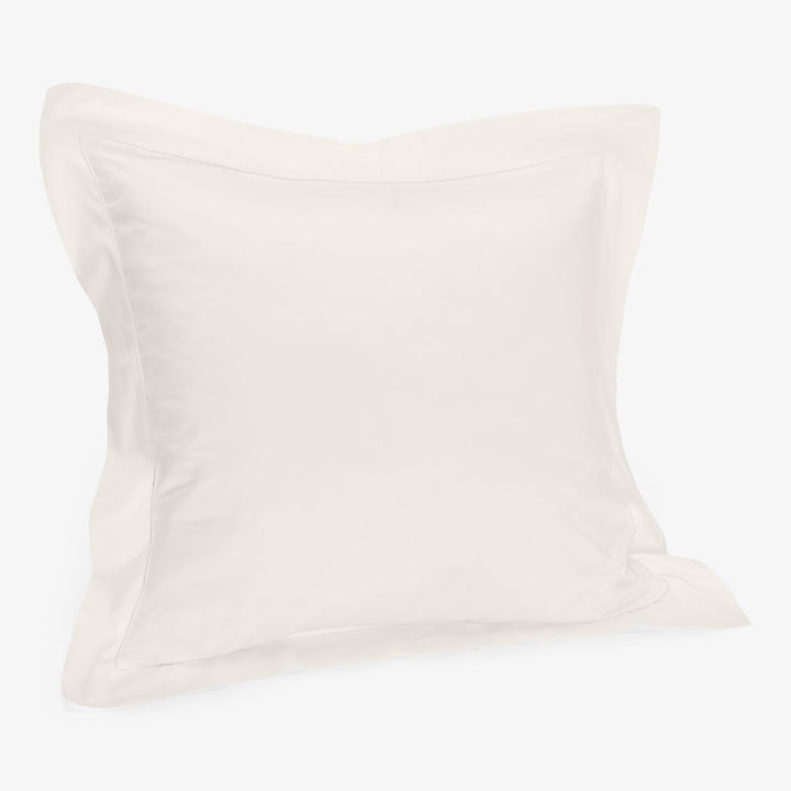 Square white pillow with soft pillowcase on white background.