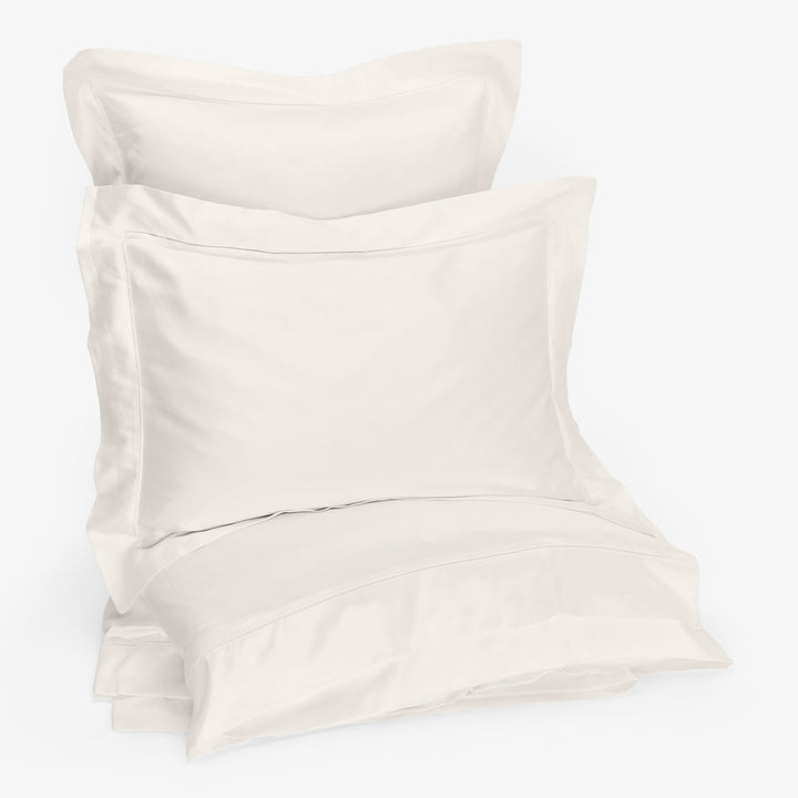 Luxurious white bedding set with pillows and duvet on display.