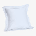 Minimalist white cotton pillow on plain white background.