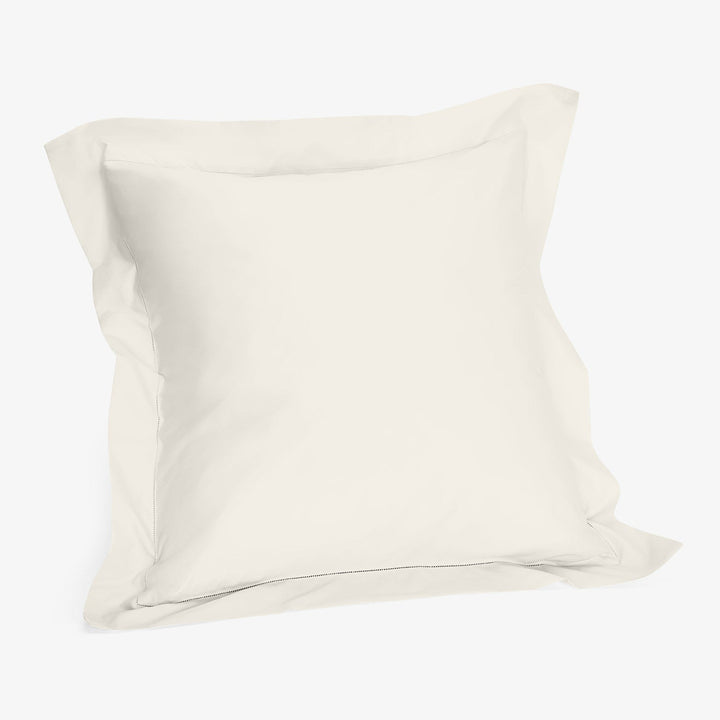 Plain off-white pillowcase made from smooth fabric for standard pillow.