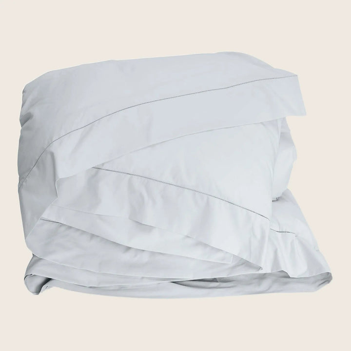 Crisp white bedding set with duvet cover and pillowcase.