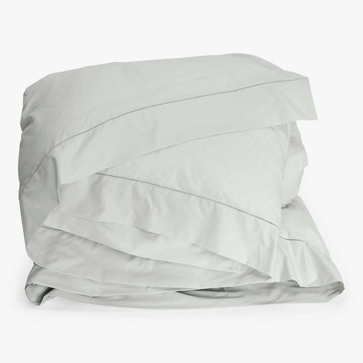 Neatly folded white duvet cover with zipper enclosure on display.