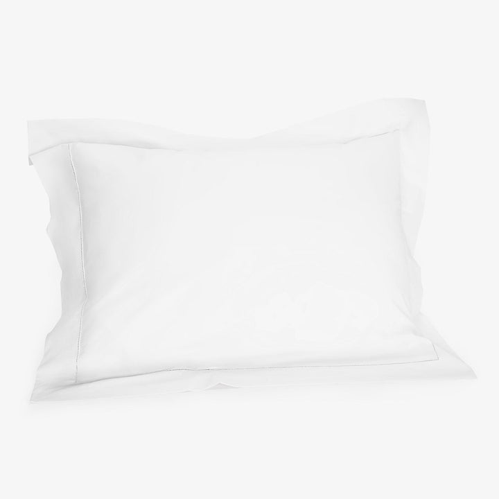 White pillow on white background, standard size, plump and fluffy.