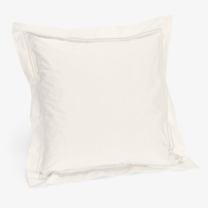 Minimalist white pillowcase with inner seam detail on smooth fabric.
