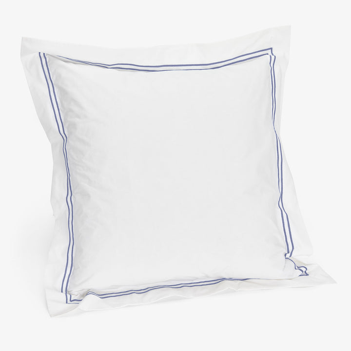 White pillow with blue border against white background, simple design.