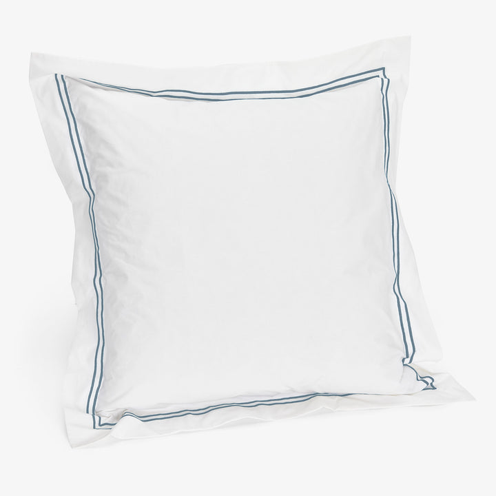 White pillowcase with blue piping for crisp, tailored look.