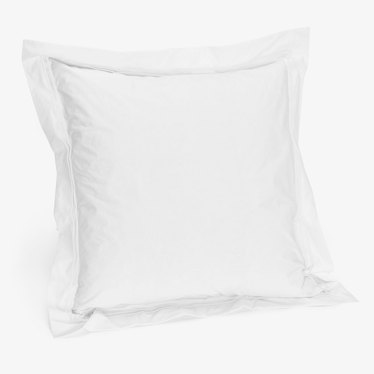 Minimalist white pillow with soft texture on plain background.