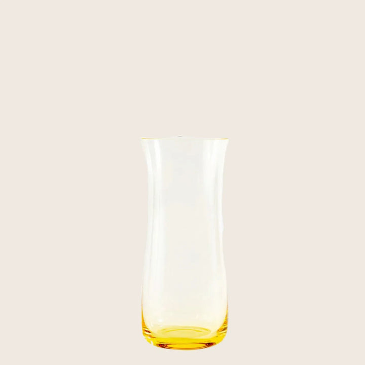 Sleek glass carafe with tapered design on light background.