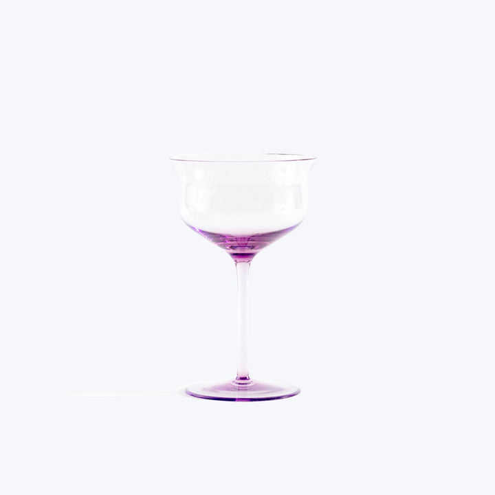 Simple elegance: empty glass goblet with purple-tinted stem and base.