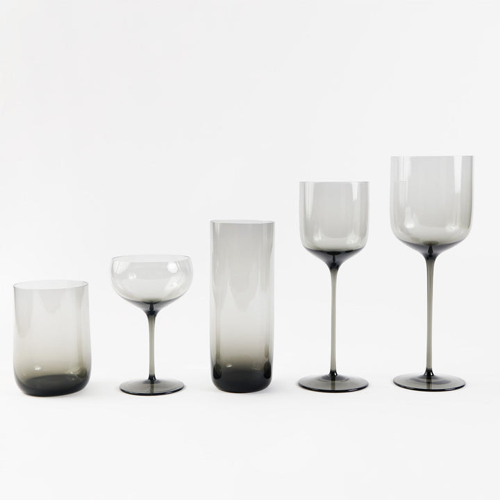 Collection of five smoky grey glassware items in similar style.