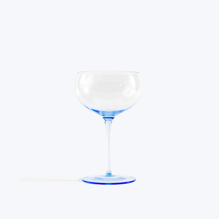 Minimalist wine glass with blue accents on white background.