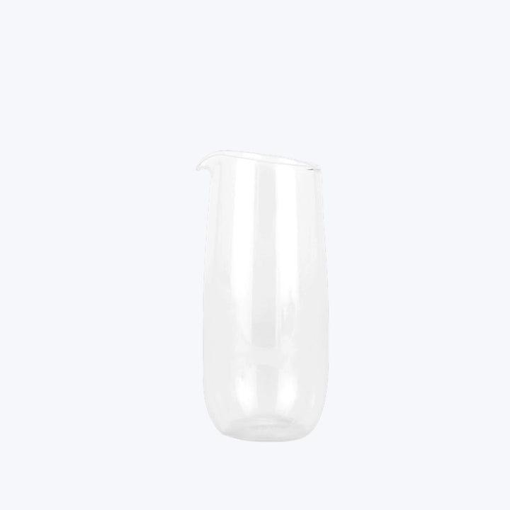 Translucent glass pitcher with sleek design on white background.
