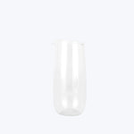 Translucent glass pitcher with sleek design on white background.