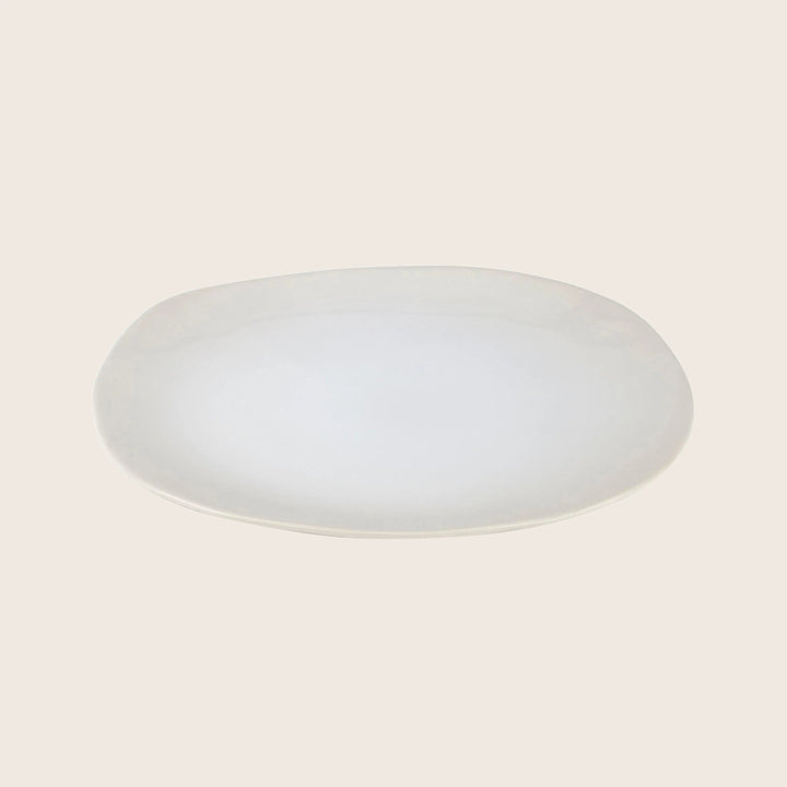 Simple oval-shaped plate with slightly elevated edge on white background.