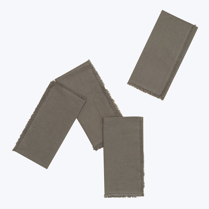 Three textured fabric swatches in earthy tones on plain background