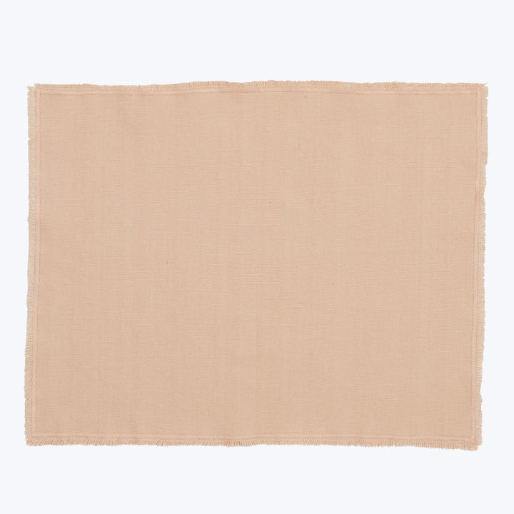 Light brown frayed edge cloth on white background, natural texture.