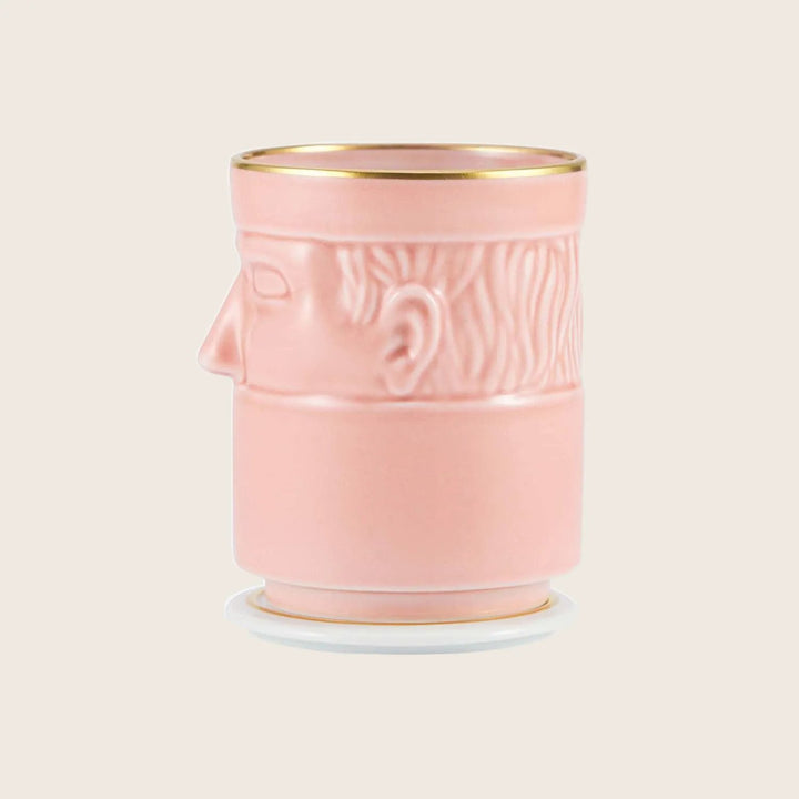 Stylized pink container with classical statue head design, gold accents.