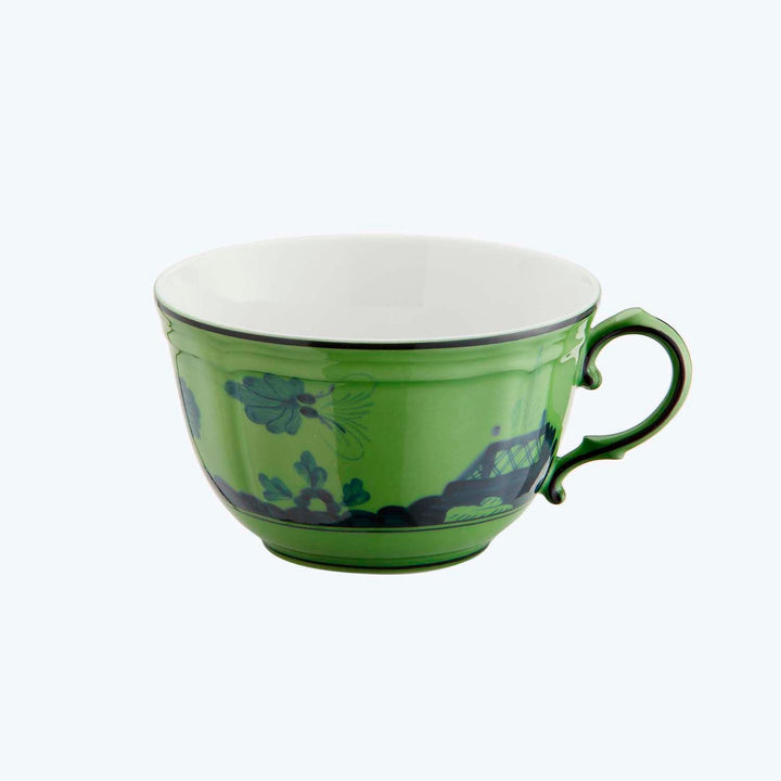 Green teacup with floral pattern and white interior, elegant design.
