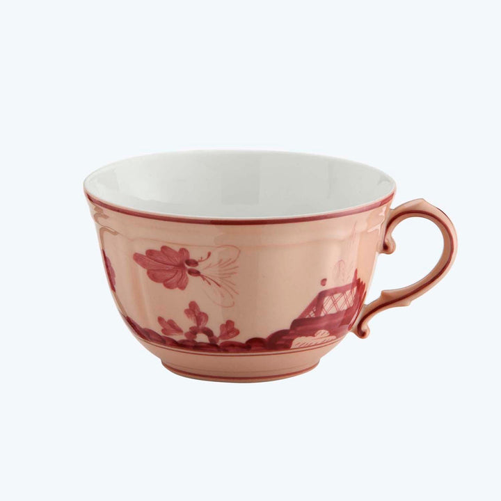 Traditional porcelain teacup with floral pattern and gazebo design.