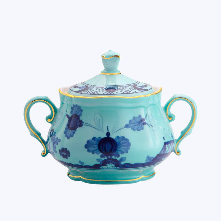 Elegant porcelain sugar bowl with floral design and gold accents.