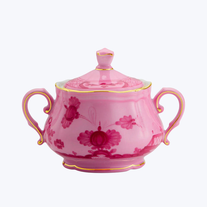 Pink sugar bowl with floral pattern, gold trim and handles.