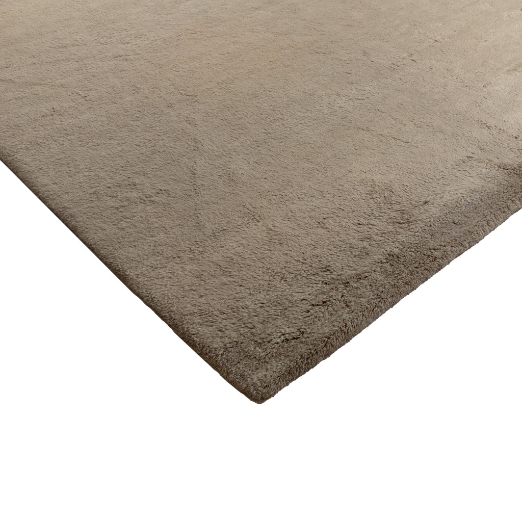 Close-up of plush beige carpet with soft, high fibers texture.