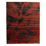 Vibrant red and black rug with abstract leaf design pattern.