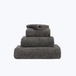 Three folded gray towels in ascending order of size.